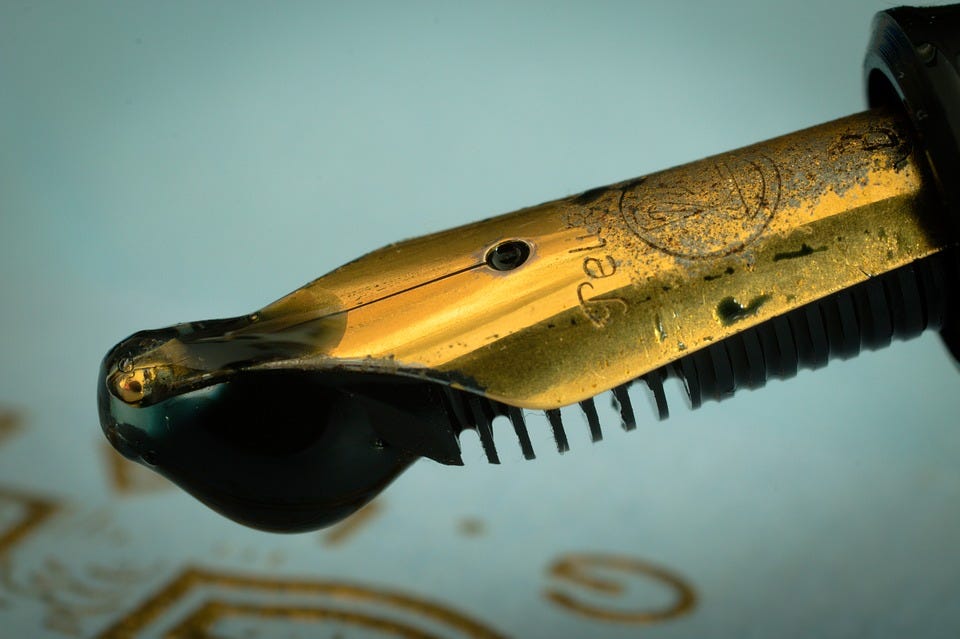 Priming a Fountain Pen for First Use A fountain pen with an ink drop at its tip